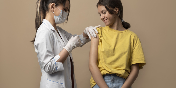 medium-shot-smiley-girl-getting-vaccinated.jpg